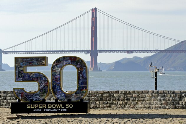 A Super Bowl 50 sign rests on the beach near the Golden Gate Bridge Friday, Feb. 5, 2016, in San Francisco. (AP Photo/Charlie Riedel)