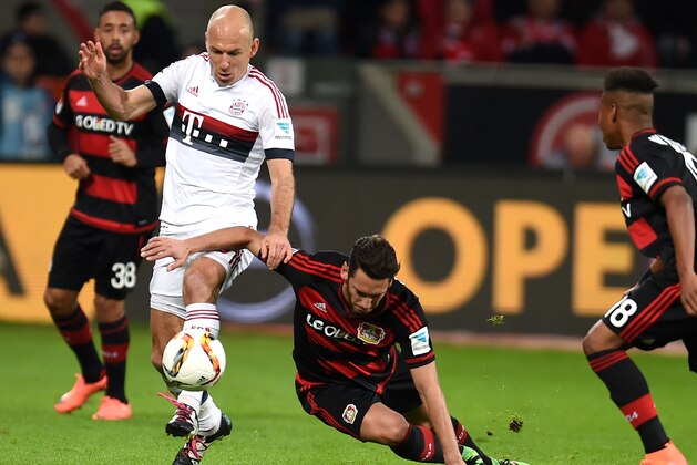 Leverkusen's midfielder Hakan Calhanoglu and Bayern Munich's Dutch midfielder Arjen Robben  vie for the ball during the German first division Bundesliga football match of Bayer 04 Leverkusen v Bayern Munich in Leverkusen, western Germany, on February 6, 2016.  / AFP / PATRIK STOLLARZ / RESTRICTIONS: DURING MATCH TIME: DFL RULES TO LIMIT THE ONLINE USAGE TO 15 PICTURES PER MATCH AND FORBID IMAGE SEQUENCES TO SIMULATE VIDEO. == RESTRICTED TO EDITORIAL USE == FOR FURTHER QUERIES PLEASE CONTACT DFL DIRECTLY AT + 49 69 650050
        (Photo credit should read PATRIK STOLLARZ/AFP/Getty Images)