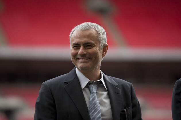 Former Chelsea manager Jose Mourinho smiles as he attends a group photo session pitchside as a guest of FIFA Presidential Candidate Gianni Infantino after unveiling his 90 day plan that he will implement if he is elected FIFA President, at Wembley Stadium in London, Monday, Feb. 1, 2016.  (AP Photo/Matt Dunham)