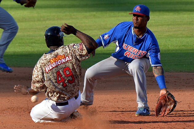 Adonis Garcia (L) of Venezuela slides safe at second base against Puerto Rico during their 2016 Caribbean baseball series game on February 6, 2016 in Santo Domingo, Dominican Republic. AFP PHOTO/YAMIL LAGE / AFP / YAMIL LAGE        (Photo credit should read YAMIL LAGE/AFP/Getty Images)