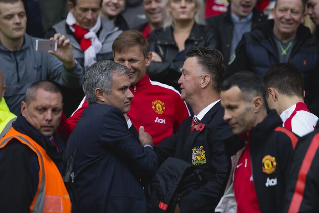 Chelsea's manager Jose Mourinho, left, greets Manchester United manager Louis van Gaal, center right, before the English Premier League soccer match between Manchester United and Chelsea at Old Trafford Stadium, Manchester, England, Sunday Oct. 26, 2014. (AP Photo/Jon Super)