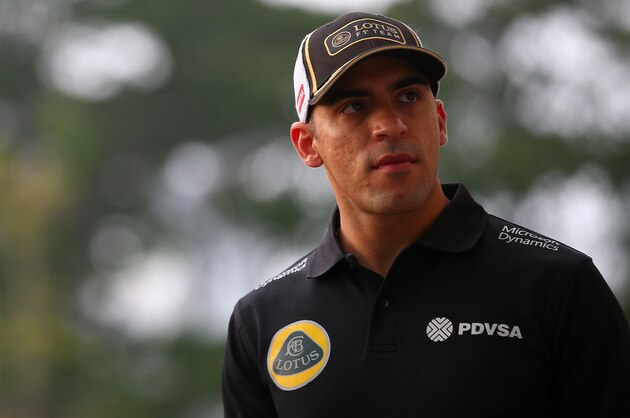SINGAPORE - SEPTEMBER 20:  Pastor Maldonado of Venezuela and Lotus walks in the paddock before the Formula One Grand Prix of Singapore at Marina Bay Street Circuit on September 20, 2015 in Singapore.  (Photo by Mark Thompson/Getty Images)
