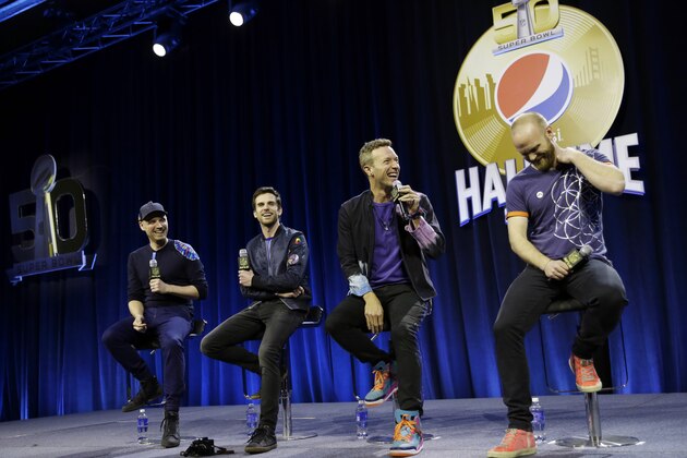 Jonny Buckland, left to right, Guy Berryman, Chris Martin and Will Champion of Coldplay answer questions during a halftime news conference for the upcoming NFL Super Bowl 50 football game Thursday, Feb. 4, 2016, in San Francisco.(AP Photo/David J. Phillip)