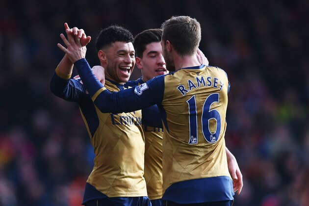 BOURNEMOUTH, ENGLAND - FEBRUARY 07:  Alex Oxlade-Chamberlain of Arsenal (L) celebrates with Hector Bellerin and Aaron Ramsey as he scores their second goal during the Barclays Premier League match between A.F.C. Bournemouth and Arsenal at the Vitality Stadium on February 7, 2016 in Bournemouth, England.  (Photo by Matthew Lewis/Getty Images)