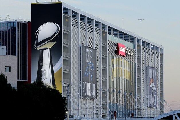 A plane flies over Levi's Stadium in advance of Sunday's NFL Super Bowl 50 football game Friday, Feb. 5, 2016, in Santa Clara, Calif. (AP Photo/Charlie Riedel)