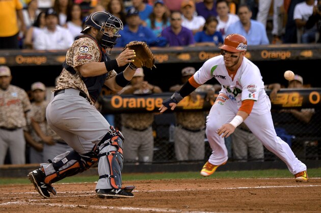 Guillermo Antonio Quiroz (L) of Mexico slides safe on home base against Venezuela during their 2016 Caribbean baseball series game on February 7, 2016 in Santo Domingo, Dominican Republic. AFP PHOTO/YAMIL LAGE / AFP / YAMIL LAGE        (Photo credit should read YAMIL LAGE/AFP/Getty Images)