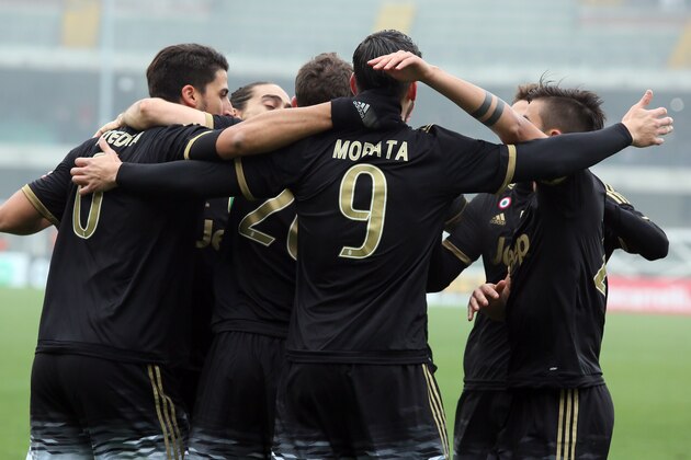 Juventus players celebrate after teammate Alvaro Morata, back to camera, scored during a Serie A soccer match at the Bentegodi stadium in Verona, Italy, Sunday, Jan. 31, 2016. (AP Photo/Felice Calabro')