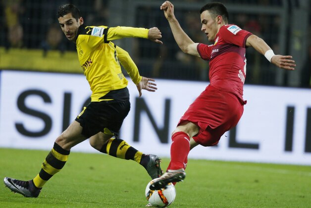Dortmund's Armenian midfielder Henrikh Mkhitaryan (L) and Stuttgart's Serbian midfielder Filip Kostic vie for the ball during the German first division Bundesliga football match Borussia Dortmund vs VfB Stuttgart, in Dortmund, western Germany, on November 29, 2015. Dortmund won the match 4-1.  AFP PHOTO / NORBERT SCHMIDT

RESTRICTIONS: DURING MATCH TIME: DFL RULES TO LIMIT THE ONLINE USAGE TO 15 PICTURES PER MATCH AND FORBID IMAGE SEQUENCES TO SIMULATE VIDEO. 
==RESTRICTED TO EDITORIAL USE ==
FOR FURTHER QUERIES PLEASE CONTACT THE DFL DIRECTLY AT + 49 69 650050. / AFP / NORBERT SCHMIDT        (Photo credit should read NORBERT SCHMIDT/AFP/Getty Images)