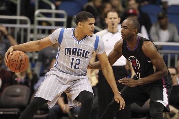 Feb 5, 2016; Orlando, FL, USA; Orlando Magic forward Tobias Harris (12) drives into Los Angeles Clippers forward Luc Richard Mbah a Moute (right) during the first quarter of a basketball game at Amway Center. Mandatory Credit: Reinhold Matay-USA TODAY Sports