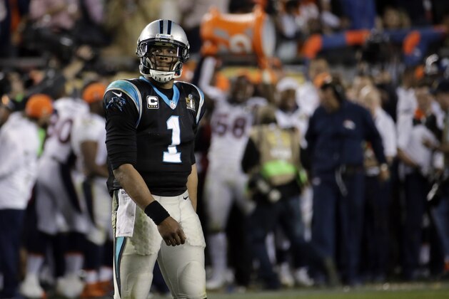 Carolina Panthers’ Cam Newton (1) walks off the field as the Denver Broncos coach get dunked in the background during the second half of the NFL Super Bowl 50 football game Sunday, Feb. 7, 2016, in Santa Clara, Calif. The Broncos beat the Carolina Panthers 24-10. (AP Photo/Matt York)