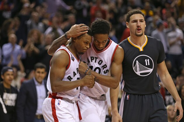 TORONTO, ON - DECEMBER 5:  DeMar DeRozan #10 of the Toronto Raptors hugs teammate Kyle Lowry #7 during the game against the Golden State Warriors on December 5, 2015 at Air Canada Centre in Toronto, Ontario, Canada. NOTE TO USER: User expressly acknowledges and agrees that, by downloading and or using this photograph, User is consenting to the terms and conditions of the Getty Images License Agreement. Mandatory Copyright Notice: Copyright 2015 NBAE (Photo by Dave Sandford/NBAE via Getty Images)