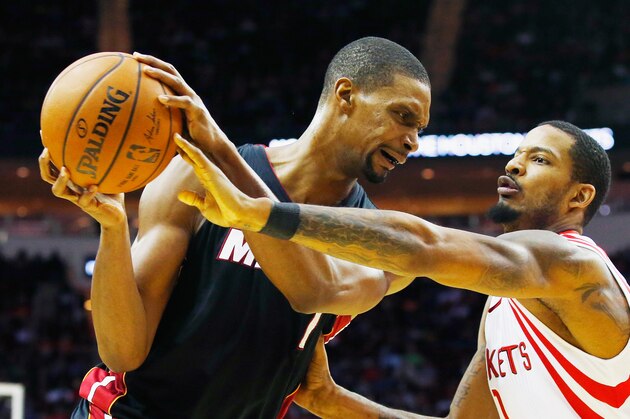HOUSTON, TX - FEBRUARY 02:   Chris Bosh #1 of the Miami Heat looks to drive with the basketball against Trevor Ariza #1 of the Houston Rockets during their game at the Toyota Center on February 2, 2016  in Houston, Texas. NOTE TO USER: User expressly acknowledges and agrees that, by downloading and or using this Photograph, user is consenting to the terms and conditions of the Getty Images License Agreement.  (Photo by Scott Halleran/Getty Images)