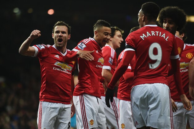 Manchester United players including Manchester United's Spanish midfielder Juan Mata (L) celebrate the opening goal scored by Manchester United's English midfielder Jesse Lingard (C) during the English Premier League football match between Manchester United and Stoke City at Old Trafford in Manchester, north west England, on February 2, 2016. / AFP / PAUL ELLIS / RESTRICTED TO EDITORIAL USE. No use with unauthorized audio, video, data, fixture lists, club/league logos or 'live' services. Online in-match use limited to 75 images, no video emulation. No use in betting, games or single club/league/player publications.  /         (Photo credit should read PAUL ELLIS/AFP/Getty Images)