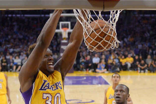 Los Angeles Lakers forward Julius Randle dunks during the first half of an NBA basketball game against the Minnesota Timberwolves, Tuesday, Feb. 2, 2016, in Los Angeles. (AP Photo/Mark J. Terrill)