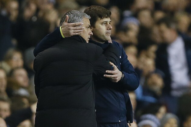 Tottenham manager Mauricio Pochettino, right, embraces Chelsea manager Jose Mourinho at the end of the English Premier League soccer match between Tottenham Hotspur and Chelsea at White Hart Lane Stadium in London, Thursday, Jan. 1, 2015. (AP Photo/Kirsty Wigglesworth)