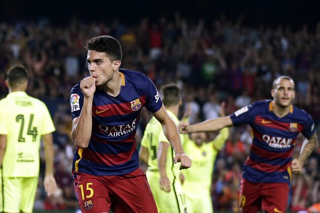 FC Barcelona's Marc Bartra celebrates after scoring against Levante during a Spanish La Liga soccer match at the Camp Nou stadium in Barcelona, Spain, Sunday, Sept. 20, 2015. (AP Photo/Manu Fernandez)