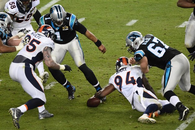Feb 7, 2016; Santa Clara, CA, USA; Carolina Panthers quarterback Cam Newton (1) steps back from a loose ball as Denver Broncos outside linebacker DeMarcus Ware (94) reaches for it during the fourth quarter in Super Bowl 50 at Levi's Stadium. Mandatory Credit: Richard Mackson-USA TODAY Sports
