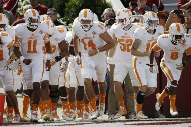 Tennessee quarterback Justin Worley (14) leads the Volunteers onto the field prior to an NCAA college football game against Alabama in Tuscaloosa, Ala., Saturday, Oct. 26, 2013. (AP Photo/Dave Martin)
