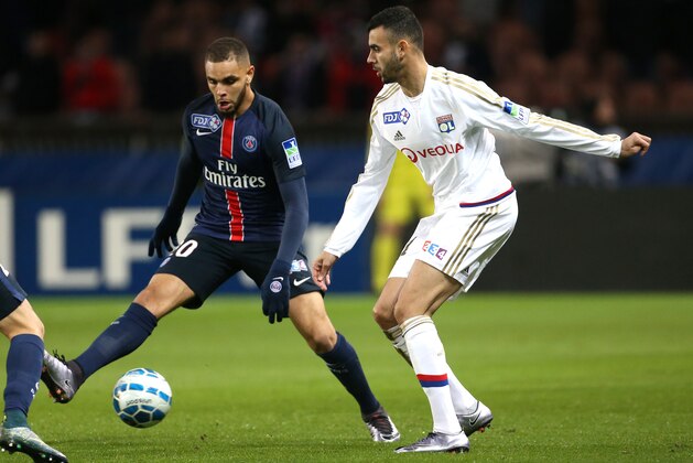 PARIS, FRANCE - JANUARY 13: Rachid Ghezzal of Lyon and Layvin Kurzawa of PSG (left) in action during the French League Cup (Coupe de la Ligue) match between Paris Saint-Germain (PSG) and Olympique Lyonnais (OL, Lyon) at Parc des Princes stadium on January 13, 2016 in Paris, France. (Photo by Jean Catuffe/Getty Images)