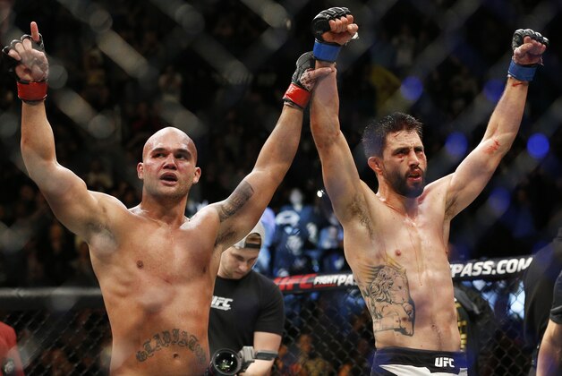Robbie Lawler, left, and Carlos Condit celebrate after their welterweight championship mixed martial arts bout at UFC 195, Saturday, Jan. 2, 2016, in Las Vegas. Lawler won the bout. (AP Photo/John Locher)