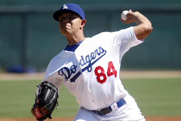 Mar 15, 2014; Phoenix, AZ, USA; Los Angeles Dodgers pitcher Julio Urias (84) throws in the first inning against the San Diego Padres at Camelback Ranch. Mandatory Credit: Rick Scuteri-USA TODAY Sports