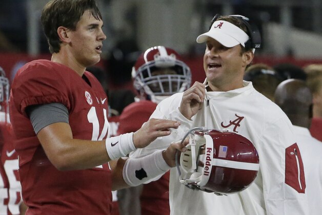 Alabama quarterback Jake Coker (14) listens to offensive coordinator Lane Kiffin on the sidelines during the second half of an NCAA college football game against Wisconsin, Saturday, Sept. 5, 2015, in Arlington, Texas. (AP Photo/LM Otero)