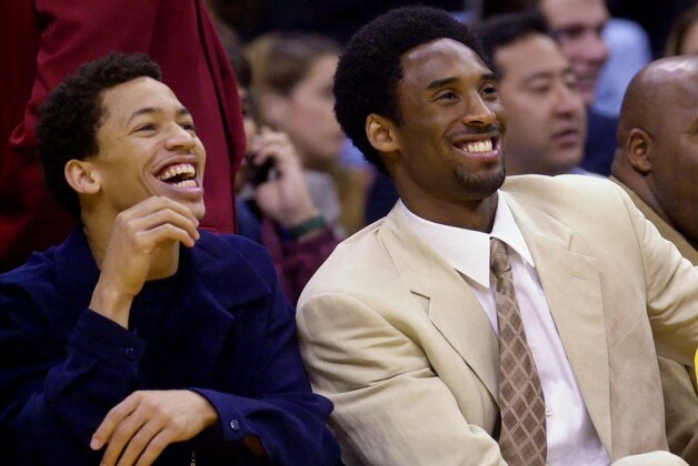 Los Angeles Lakers' Tyronn Lue, left, Kobe Bryant, center, and Brian Shaw are all smiles as they watch their teammates play the Washington Wizards in the second quarter Friday, March 23, 2001, in Los Angeles. Bryant's sore left ankle already is feeling better, coach Phil Jackson said, but the star guard is expected to miss at least three games. Lakers guard Lue, who has a sprained ankle,  was placed on the injured list Friday. (AP Photo/Kevork Djansezian)