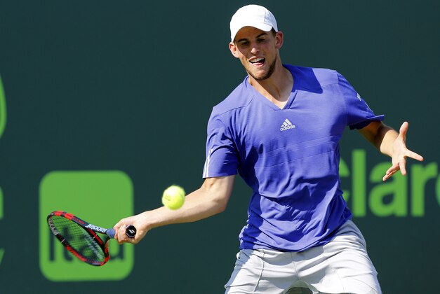 Apr 1, 2015; Key Biscayne, FL, USA; Dominic Thiem hits a forehand against Andy Murray (not pictured) on day ten of the Miami Open at Crandon Park Tennis Center. Murray won 3-6, 6-4, 6-1. Mandatory Credit: Geoff Burke-USA TODAY Sports