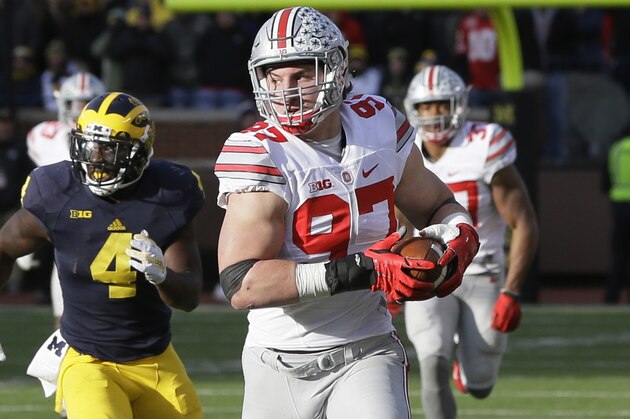 Ohio State defensive end Joey Bosa runs from Michigan running back De'Veon Smith after intercepting a pass during the second half of an NCAA college football game, Saturday, Nov. 28, 2015, in Ann Arbor, Mich. (AP Photo/Carlos Osorio)