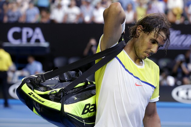 Rafael Nadal of Spain packs his bags as he leaves Rod Laver Arena following his loss to compatriot Fernando Verdasco in their first round match at the Australian Open tennis championships in Melbourne, Australia, Tuesday, Jan. 19, 2016.(AP Photo/Mark Baker)