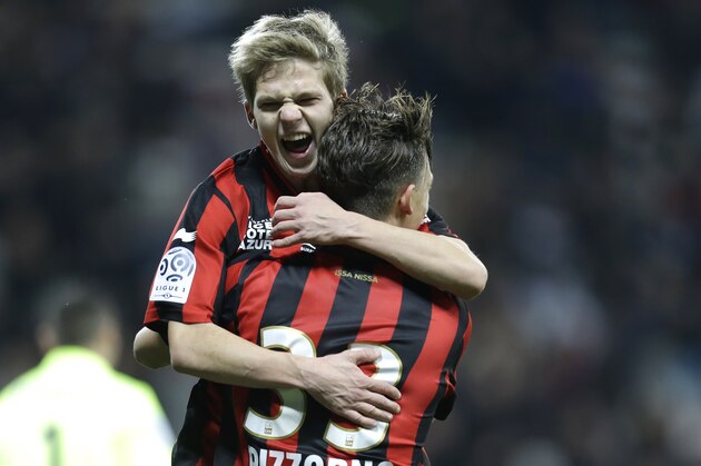 Nice's Olivier Boscagli, right, is congratulated by teammate Vincent Koziello after scoring the first goal against Montpellier, during their French League One soccer match, Friday, Dec. 18, 2015, in Nice stadium, southeastern France. (AP Photo/Lionel Cironneau)