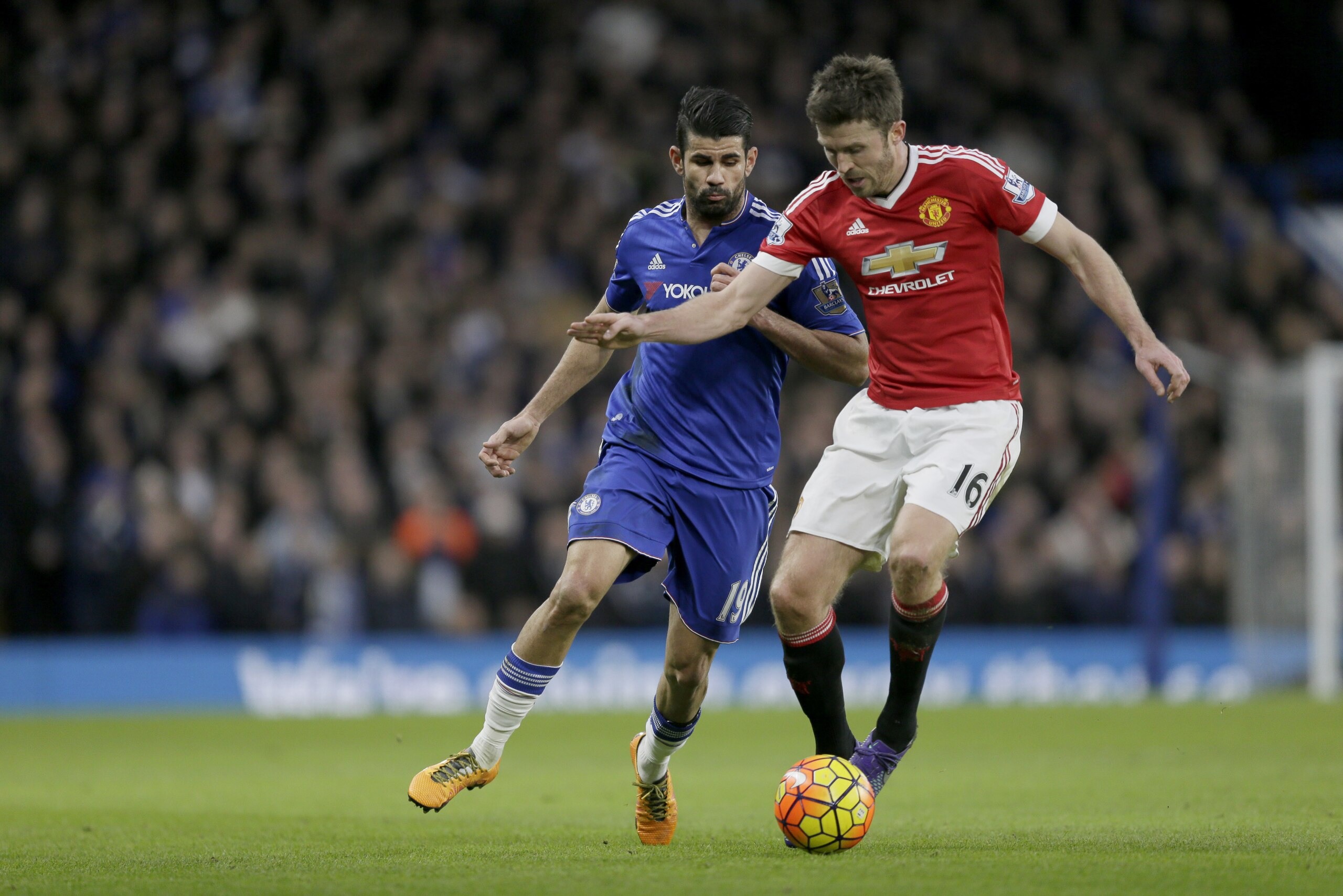 Chelsea's Diego Costa, left, competes for the ball with Manchester United's Michael Carrick during the English Premier League soccer match between Chelsea and Manchester United at Stamford Bridge stadium in London, Sunday, Feb. 7, 2016.  (AP Photo/Tim Ireland)
