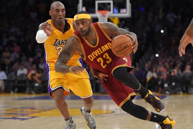 Cleveland Cavaliers forward LeBron James, right, drives toward the basket as Los Angeles Lakers guard Kobe Bryant defends during the second half of an NBA basketball game, Thursday, Jan. 15, 2015, in Los Angeles.  The Cavaliers won 109-102. (AP Photo/Mark J. Terrill)