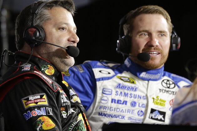 Drivers Tony Stewart, left, and Brian Vickers take part in a television interview during NASCAR media day at Daytona International Speedway, Thursday, Feb. 12, 2015, in Daytona Beach, Fla. (AP Photo/John Raoux)