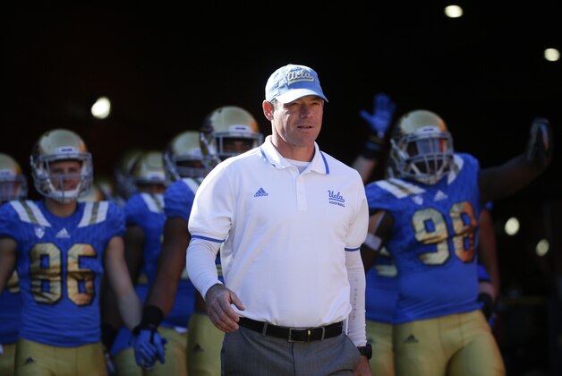 UCLA head coach Jim Mora leads his team onto the field before an NCAA college football game against Southern California, Saturday, Nov. 28, 2015, in Los Angeles. (AP Photo/Jae C. Hong)