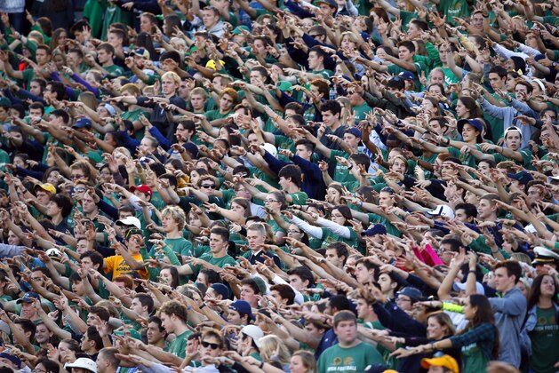 The student section at Notre Dame Stadium wave their arms during the second half of an NCAA college football game against Navy, Saturday, Oct. 10, 2015, in South Bend, Ind. Notre Dame won the game 41-24. (AP Photo/Jeff Haynes)