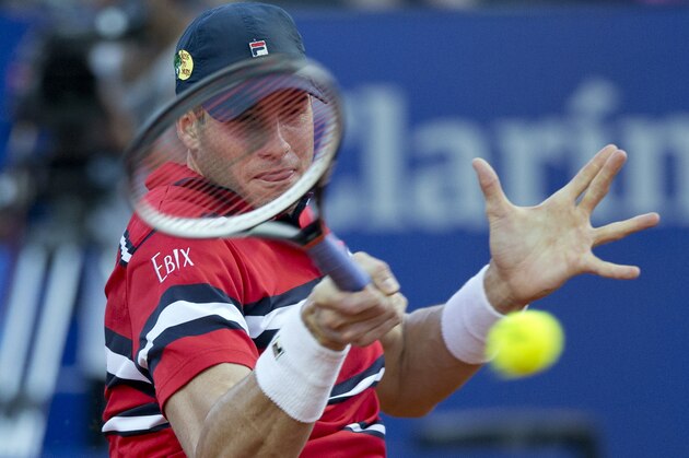 John Isner of the United States returns the ball to Dusan Lajovic of Serbia during the ATP Argentina Open in Buenos Aires, Argentina, Wednesday, Feb. 10, 2016. (AP Photo/Natacha Pisarenko)