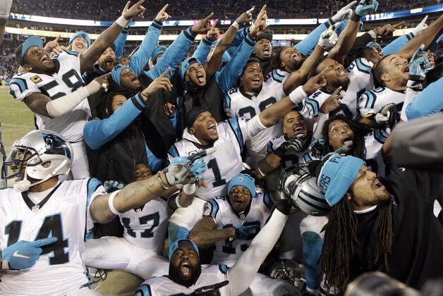 Some Carolina Panthers celebrate from the bench during the second half the NFL football NFC Championship game against the Arizona Cardinals, Sunday, Jan. 24, 2016, in Charlotte, N.C. (AP Photo/Chuck Burton)