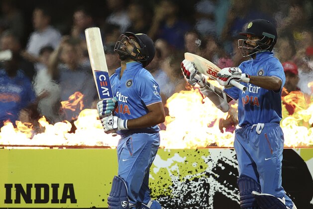 Indian batsmen Rohit Sharma left, and Shikhar Dhawan walk onto the field during their T20 International cricket match against Australia in Sydney, Australia, Sunday, Jan. 31, 2016.(AP Photo/Rob Griffith)