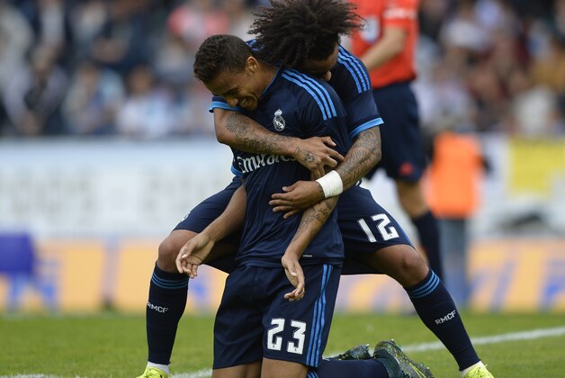 Real Madrid's Brazilian defender Danilo (L) is congratulated by Brazilian defender Marcelo after scoring a goal during the Spanish league football match Celta Vigo vs Real Madrid CF at the Balaidos stadium in Vigo on October 24, 2015.  AFP PHOTO / MIGUEL RIOPA        (Photo credit should read MIGUEL RIOPA/AFP/Getty Images)
