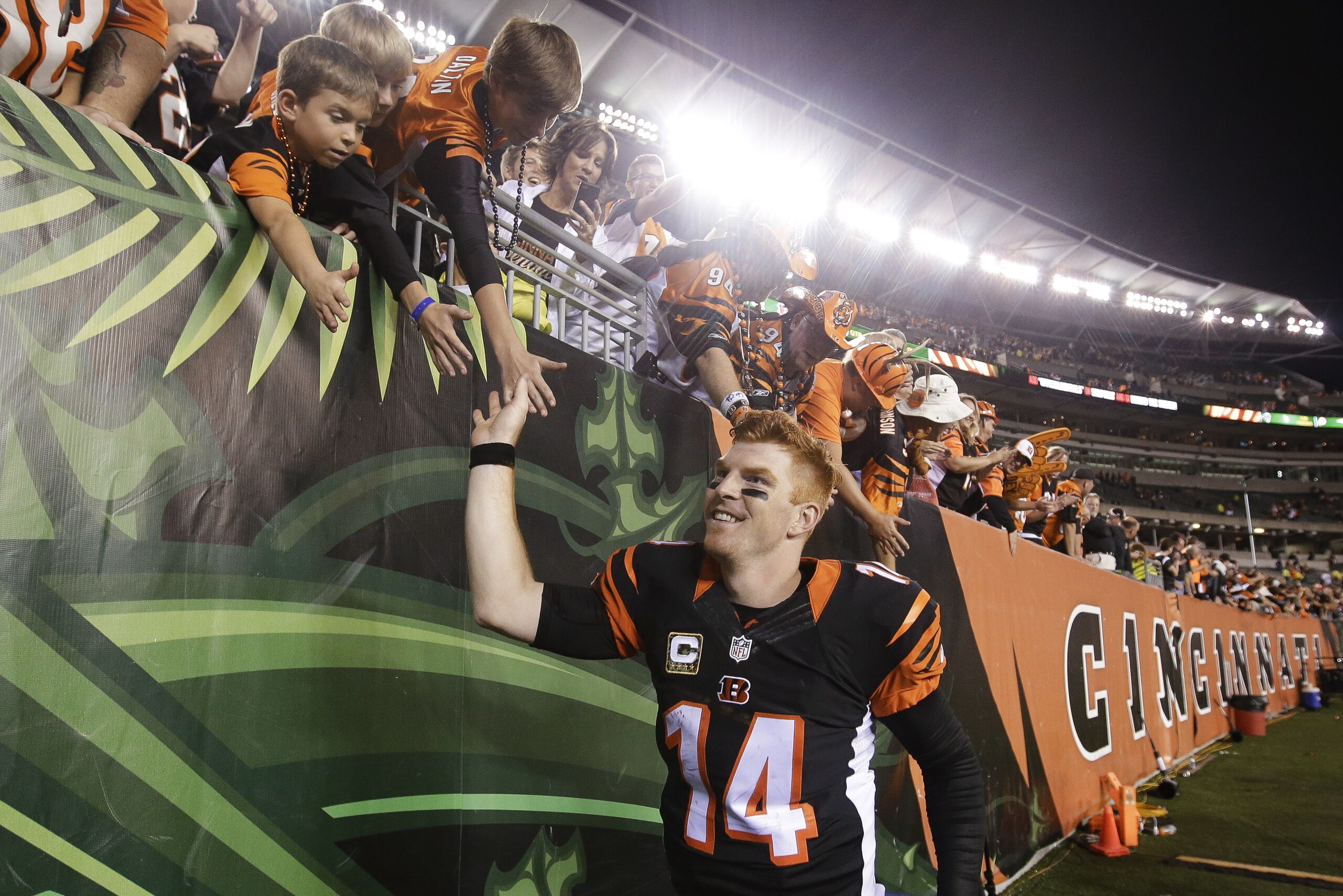 Cincinnati Bengals quarterback Andy Dalton celebrates with fans after the Bengals defeated the Cleveland Browns 31-10 in an NFL football game Thursday, Nov. 5, 2015, in Cincinnati. (AP Photo/Darron Cummings)