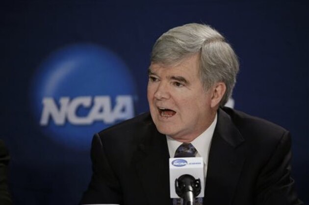 FILE - In this April 6, 2014, file phot, NCAA President Mark Emmert answers a question at a news conference in Arlington, Texas. Testifying in a landmark antitrust lawsuit filed against his organization, Emmert said Thursday, June 19, 2014, he believes there is a clear difference between the proposal to pay athletes a few thousand more dollars a year and giving them the equivalent of a salary. Emmert's testimony came in a much-anticipated appearance as the NCAA tries to convince U.S. District Judge Claudia Wilken that its system of so-called amateurism is not anti-competitive and is the best model for regulating college sports. (AP Photo/David J. Phillip, File)