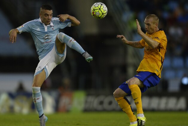 Celta Vigo's forward Iago Aspas (L) vies with Barcelona's French defender Jeremy Mathieu during the Spanish league football match Celta Vigo vs FC Barcelona at the Balaidos stadium in Vigo on September 23, 2015.  Celta won the match 4-1. AFP PHOTO / MIGUEL RIOPA        (Photo credit should read MIGUEL RIOPA/AFP/Getty Images)