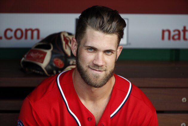 Washington Nationals right fielder Bryce Harper (34) sits in the dugout before a baseball game against the Miami Marlins at Nationals Park, Saturday, Aug. 29, 2015, in Washington.  (AP Photo/Alex Brandon)