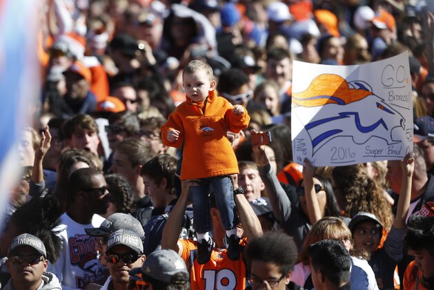 Fans at a rally following a parade through downtown Tuesday, Feb. 9, 2016 in Denver. Fans crowded into Denver's downtown to salute the Broncos for the team's victory over the Carolina Panthers in Super Bowl 50. (AP Photo/David Zalubowski)