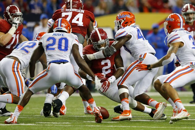 ATLANTA, GA - DECEMBER 5: Running back Derrick Henry #2 of the Alabama Crimson Tide fumbles the ball against linebacker Jarrad Davis #40 of the Florida Gators and defensive back Marcus Maye #20 of the Florida Gators in the second quarter during the SEC Championship at the Georgia Dome on December 5, 2015 in Atlanta, Georgia. (Photo by Kevin C. Cox/Getty Images)