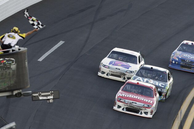 Trevor Bayne, front, beats Carl Edwards, second from right, David Gilliland, left, and Bobby Labonte, right, to the finish line to win the Daytona 500 NASCAR auto race at Daytona International Speedway in Daytona Beach, Fla., Sunday, Feb. 20, 2011. (AP Photo/David Graham)