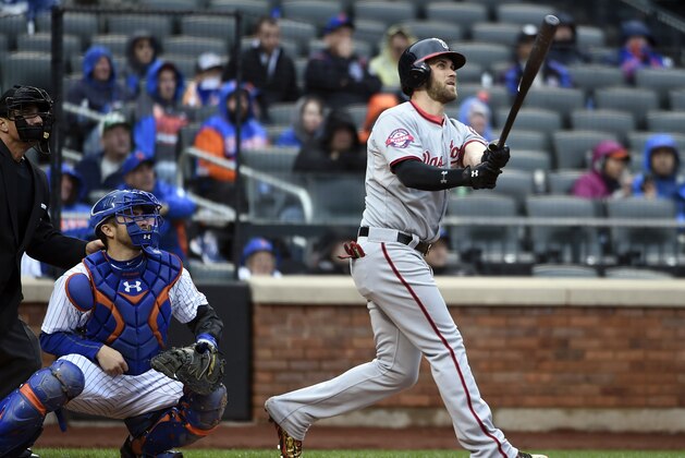 New York Mets catcher Travis d'Arnaud (7) and Washington Nationals' Bryce Harper (34) watch Harper's two-run home run in the eighth inning of the first baseball game of a doubleheader, Saturday, Oct. 3, 2015, in New York. The Nationals won 3-1. (AP Photo/Kathy Kmonicek)