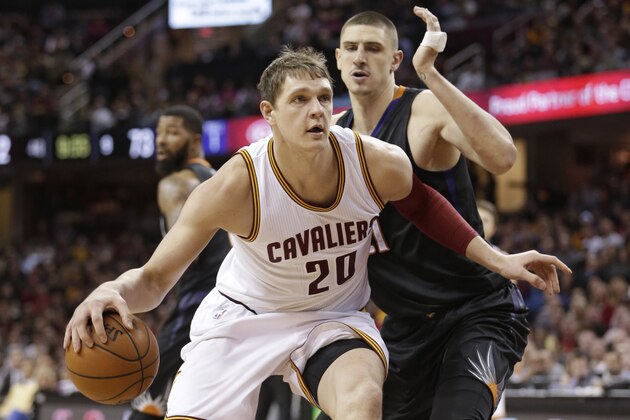 Cleveland Cavaliers' Timofey Mozgov (20), from Russia, drives past Phoenix Suns’ Alex Len (21), from Ukraine, during the second half of an NBA basketball game Wednesday, Jan. 27, 2016, in Cleveland. The Cavaliers won 115-93. (AP Photo/Tony Dejak)