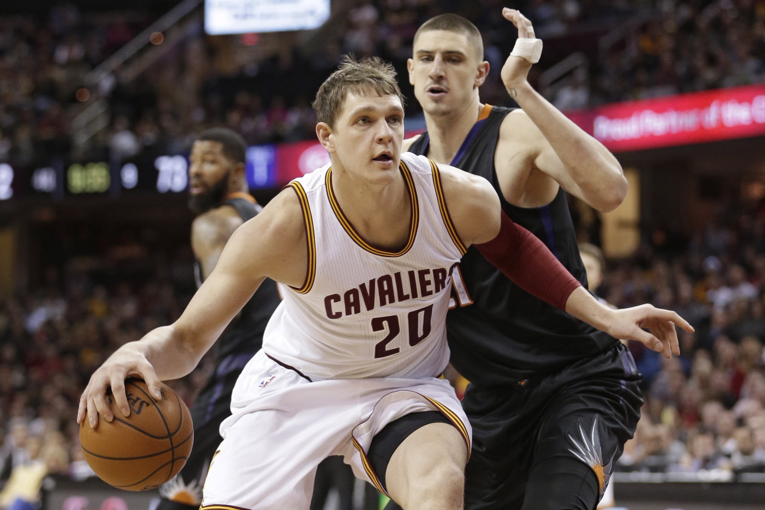 Cleveland Cavaliers' Timofey Mozgov (20), from Russia, drives past Phoenix Suns’ Alex Len (21), from Ukraine, during the second half of an NBA basketball game Wednesday, Jan. 27, 2016, in Cleveland. The Cavaliers won 115-93. (AP Photo/Tony Dejak)